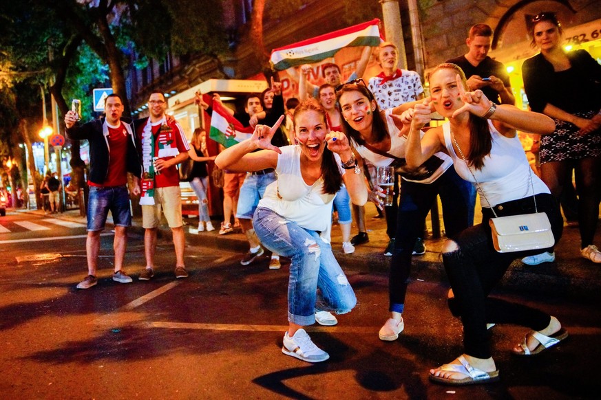 epa05365694 Hungarian fans celebrate in a street in central Budapest, Hungary, late 14 June 2016, after Hungary defeated Austria 2-0 during their soccer Euro 2016 Group F first round match in Bordeaux ...