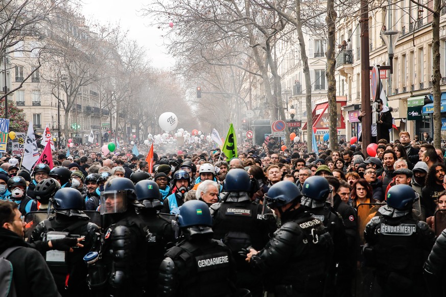 epa10461330 Riot police contain protesters during the demonstration against the government&#039;s reform of the pension system in Paris, France, 11 February 2023. The French government plans to raise  ...