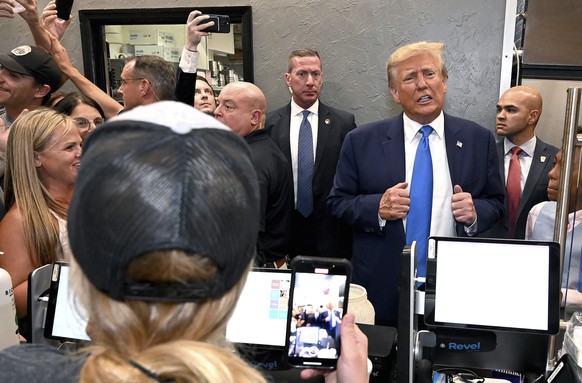 Former President Donald Trump stops by Downtown House of Pizza and places an order to go after speaking at the Lee County Republican dinner in Fort Myers, Fla., Friday, April 21, 2023. (AP Photo/Chris ...
