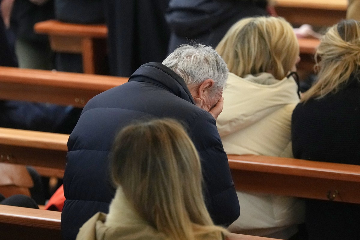 People attend a New Year mass at the catholic church of Montana Station to remember the victims of the devastating fire at the Le Constellation bar, which left dead and injured during the New Year ...