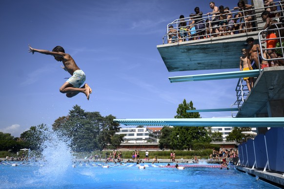 epa10815625 People cool off in the water during hot weather at the public swimming pool Bellerive on the shore of the Geneva Lake in Lausanne, Switzerland, 23 August 2023. The city of Lausanne has dec ...