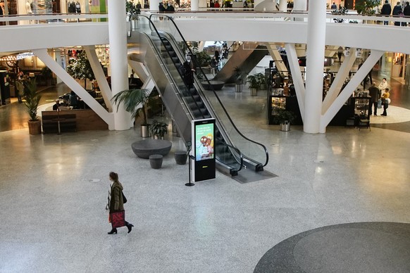 People roam a shopping centre in Gothenburg, Sweden, as the temporary pandemic law is put in place by the Swedish government to restrict public contact, Sunday Jan. 10, 2021. A maximum of one person i ...