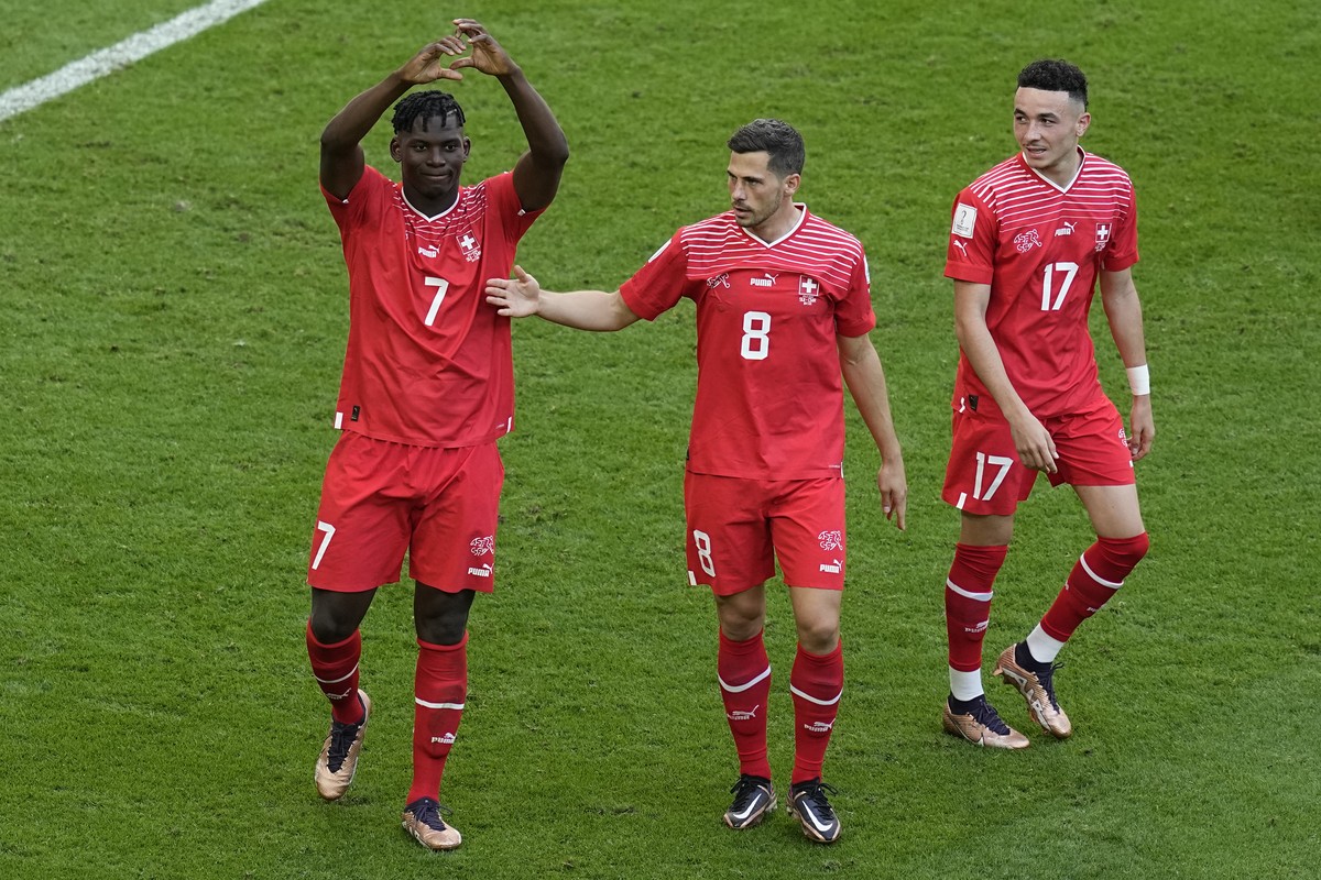 Switzerland's Breel Embolo, left, celebrates after scoring his side's opening goal during the World Cup group G soccer match between Switzerland and Cameroon, at the Al Janoub Stadium in Al  ...