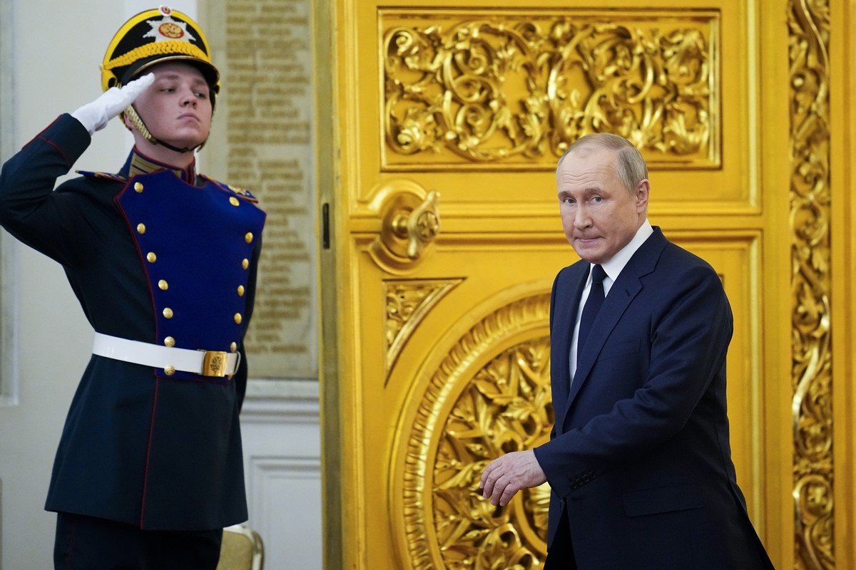 Russian President Vladimir Putin arrives to deliver his speech during an awarding ceremony for the Russian Olympic Committee medalists of the XXIV Olympic Winter Games in Beijing and members of the Ru ...