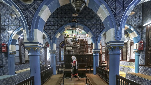FILE - A tourist visits La Ghriba, the oldest synagogue in Africa, on the island of Djerba, in southern Tunisia, Oct.  28, 2015. Tunisia's interior ministry says a marine guard shot and killed a colleague...