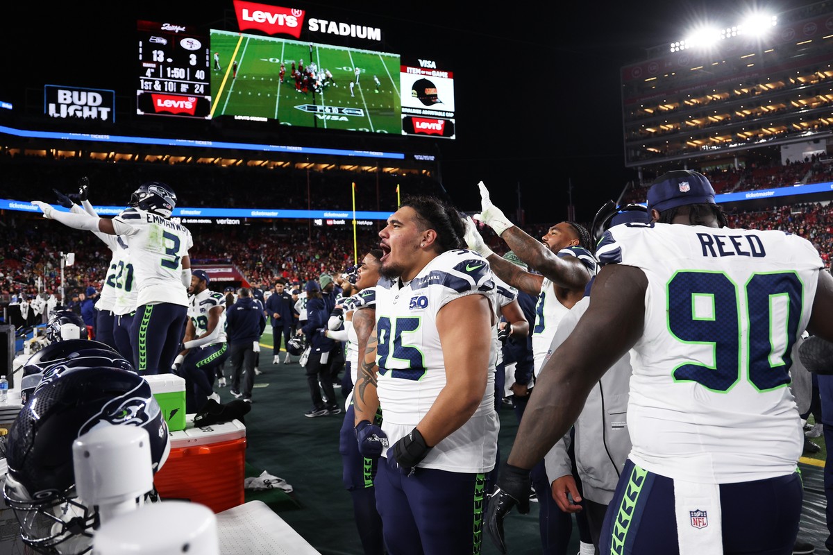Seattle Seahawks defensive tackle Brandon Pili (95), defensive tackle Jarran Reed (90) and teammates celebrate on the sideline during the second half of an NFL football game against the San Francisco  ...