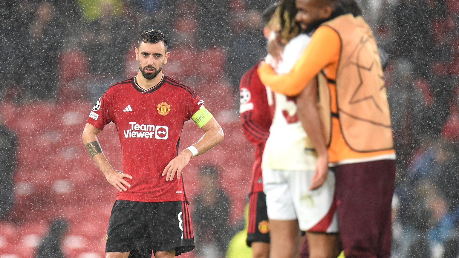 epa10898481 Bruno Fernandes of Manchester United looks at Galatasaray players celebrating after the UEFA Champions League Group A match between Manchester United and Galatasaray Istanbul in Manchester ...
