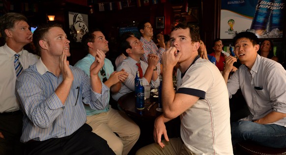 epa04284019 Fans gathered at a bar react to action at the end of the match of the FIFA 2014 World Cup between the United States and Germany on television in New York, New York, USA, 26 June 2014. Germ ...