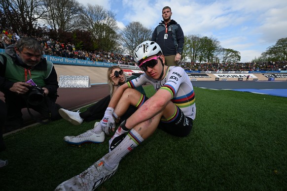 epa12030175 Second placed Slovenian rider Tadej Pogacar of UAE Team Emirates (R) and his fiancee, Slovenian cyclist Urska Zigart of Slovenia react after the Paris-Roubaix one-day cycling classic over  ...