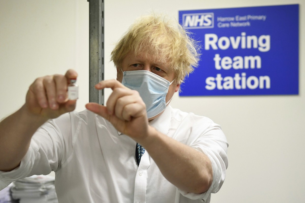 Britain's Prime Minister Boris Johnson holds a vial of the Oxford Astrazeneca coronavirus vaccine, during a visit to Barnet FC's ground at the Hive, which is being used as a coronavirus vacc ...