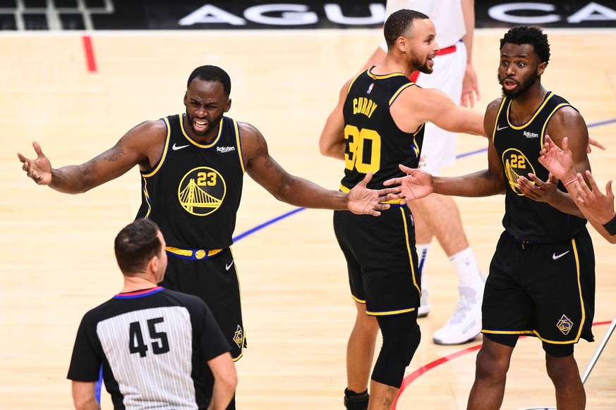 LOS ANGELES, CA - NOVEMBER 28: Golden State Warriors Forward Draymond Green 23, Golden State Warriors Guard Stephen Curry 30 and Golden State Warriors Forward Andrew Wiggins 22 reacts to a foul call t ...