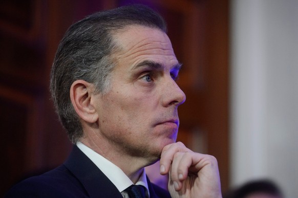 FILE - Hunter Biden listens while his father, President Joe Biden, speaks during a Hanukkah reception in the East Room of the White House in Washington, Dec. 16, 2024. (AP Photo/Rod Lamkey, Jr., File) ...