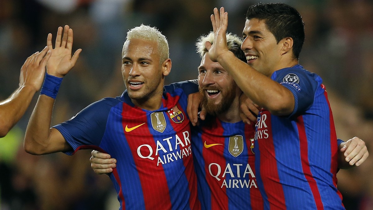Barcelona's Lionel Messi, center, celebrates with his teammates Luis Suarez, right, and Neymar after scoring his side's fifth goal during a Champions League, Group C soccer match between Bar ...