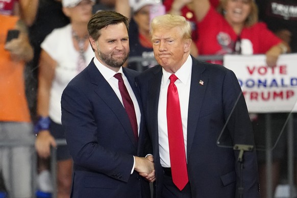 FILE - Republican vice presidential candidate Sen. JD Vance, R-Ohio, left, and Republican presidential candidate former President Donald Trump, shake hands at a campaign rally in Atlanta, Aug. 3, 2024 ...