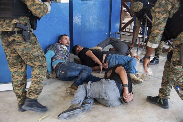 Suspects in the assassination of Haiti&#039;s President Jovenel Moise are tossed on the floor after being detained, at the General Direction of the police in Port-au-Prince, Haiti, Thursday, July 8, 2 ...