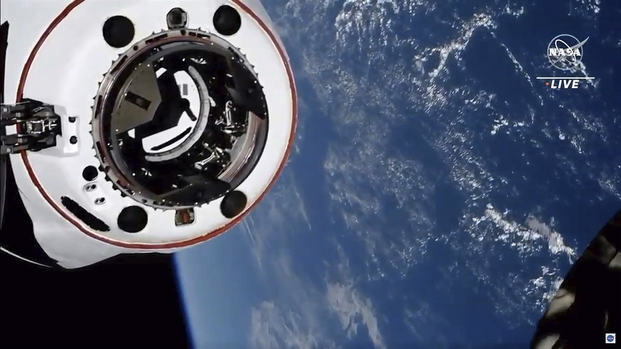 This image made from NASA TV shows the SpaceX Crew Dragon spacecraft, with the Earth behind, approaching the international space station, Saturday, April 24, 2021. The recycled SpaceX capsule carrying ...