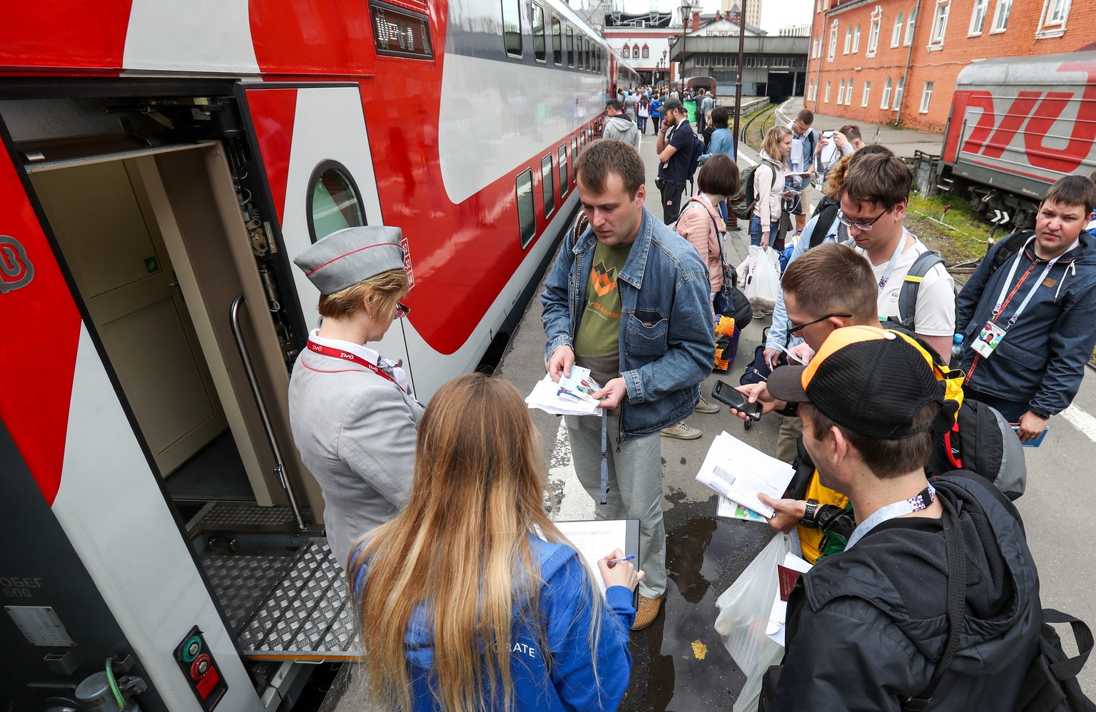 MOSCOW, RUSSIA - JUNE 13, 2018: Football fans seen by the first RZD train, carrying the 2018 FIFA World Cup fans from Moscow to Sochi, before the departure from the Kazansky railway station. 728 extra ...