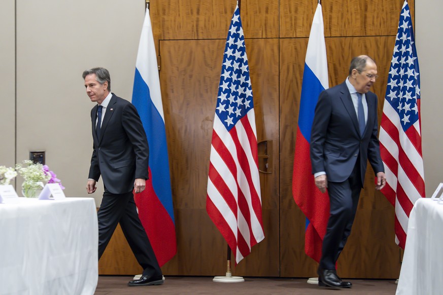 U.S. Secretary of State Antony Blinken, left, shake hands with Russian Foreign Minister Sergei Lavrov, right, arrive for their meeting in Geneva, Switzerland, Friday, Jan. 21, 2022. (Martial Trezzini/ ...