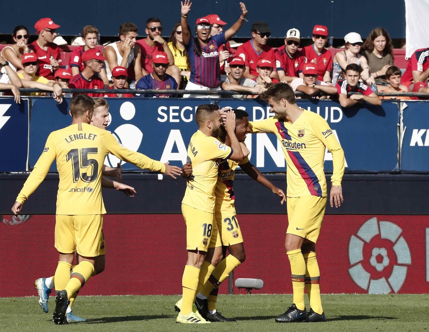 epa07807990 FC Barcelona's Ansu Fati (2-R) celebrates with teammates after scoring during the Spanish LaLiga soccer match between CA Osasuna and FC Barcelona at the El Sadar staidum in Pamplona, Spain ...