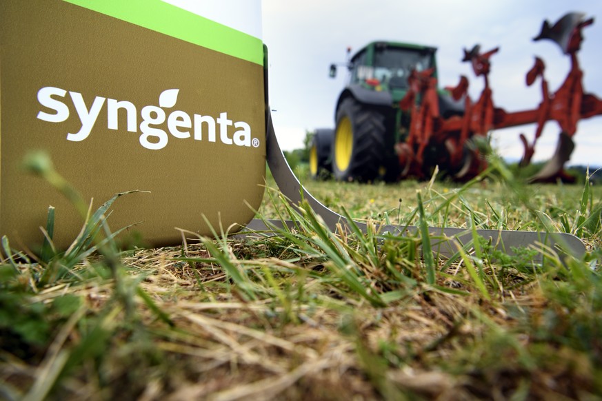 The Syngenta logo is pictured next to a tractor during a visit of the farm pilot of Patrice Schneider, that uses the most modern sustainable farming practices of Syngenta, after a press conference of  ...