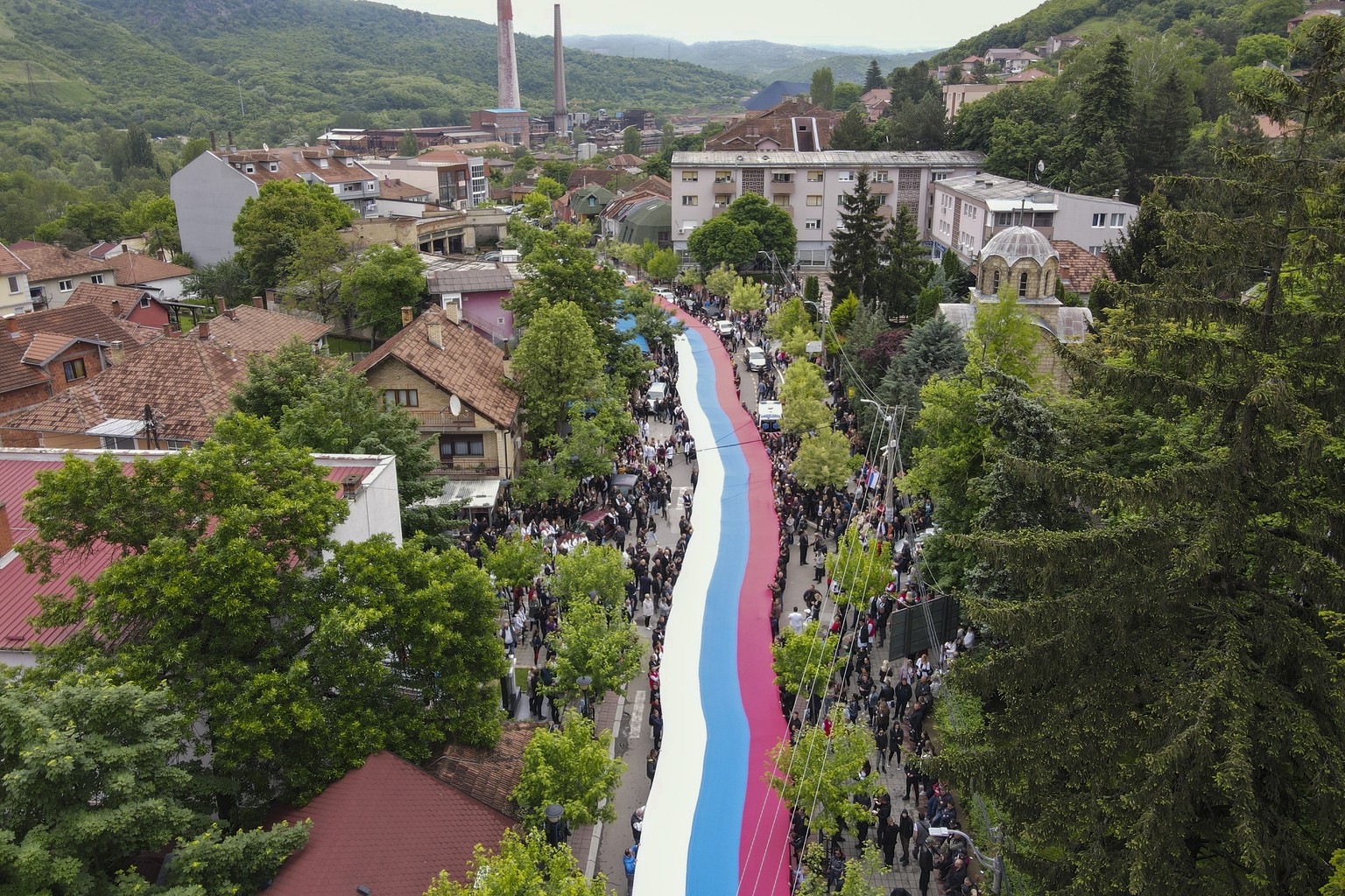 People hold a giant Serbian flag during a protest in the town of Zvecan, northern Kosovo, Wednesday, May 31, 2023. Hundreds of ethnic Serbs began to gather in front of the town hall in their repeated…