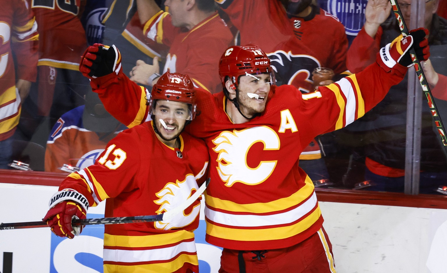 Calgary Flames forward Matthew Tkachuk, right, celebrates his goal against the Edmonton Oilers with forward Johnny Gaudreau during the third period of Game 1 of an NHL hockey second-round playoff seri ...