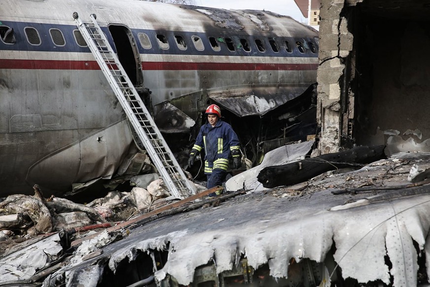 epa07281965 A firefighter walks near the wreckage of a Boeing 707 cargo plane that crashed while landing at Fath airport, near the city of Karaj, Alborz province, Iran, 14 January 2019. According to m ...