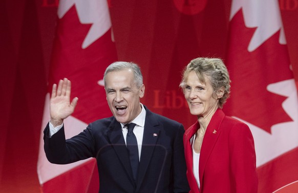 Newly appointed Liberal Leader Mark Carney and his wife Diana Fox Carney leave the stage following his speech at the Liberal leadership announcement in Ottawa, Ontario, Sunday, March 9, 2025. (Adrian  ...