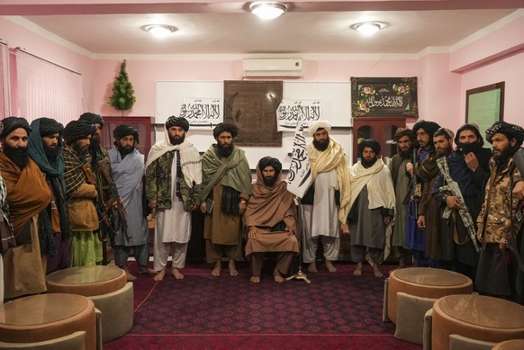 Badghis Deputy Governor Molwi Mohibullah Asad (in the middle) and other members of Taliban line up for the interview in the governors office in Qala-e-Naw Afghanistan, Saturday, Dec. 13, 2021. Severe  ...