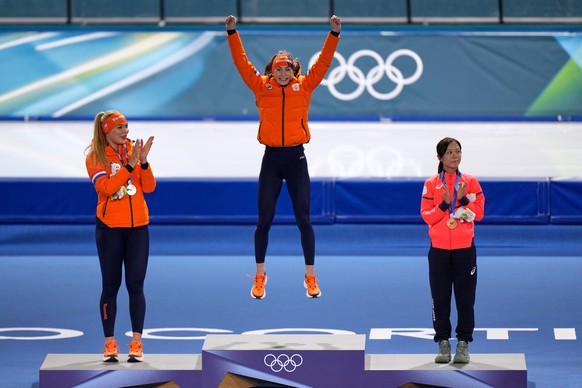 Femke Kok of the Netherlands, center and gold medal celebrates with Jutta Leerdam of the Netherlands, left and silver medal, and Miho Takagi of Japan, right and bronze medal, on the podium of the wome ...
