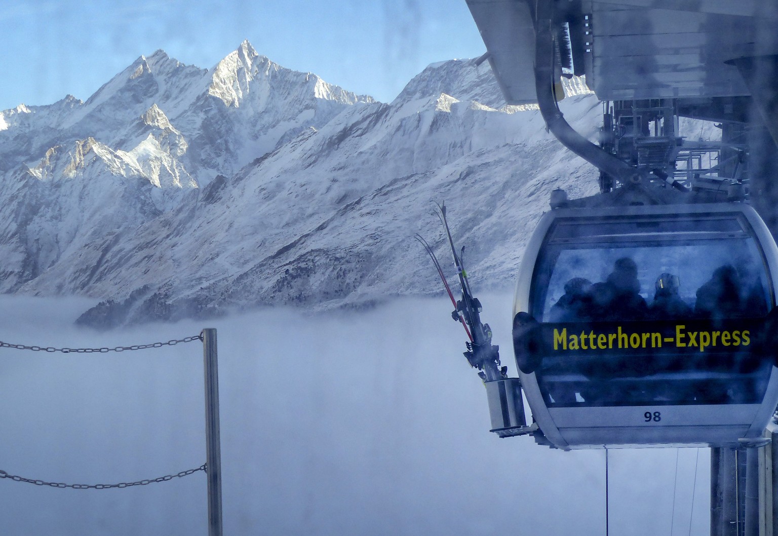A gondola goes up next to the mountains around Zermatt, Switzerland, Thursday, Dec.3, 2020. Zermatt is home to one of the Swiss ski stations that has become an epicenter of discord among Alpine neighb ...