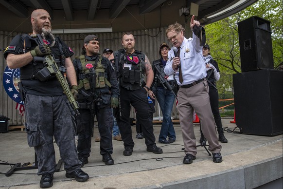 Barry County Sheriff Dar Leaf, front right, speaks next to members of the Michigan Liberty Militia during the &quot;American Patriot Rally-Sheriffs speak out&quot; event at Rosa Parks Circle in downto ...