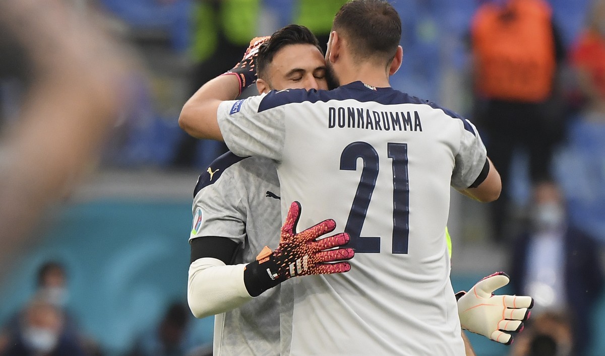 Italy's goalkeeper Gianluigi Donnarumma, right, embraces Italy's goalkeeper Salvatore Sirigu as he replaces him during the Euro 2020 soccer championship group A match between Italy and Wales ...