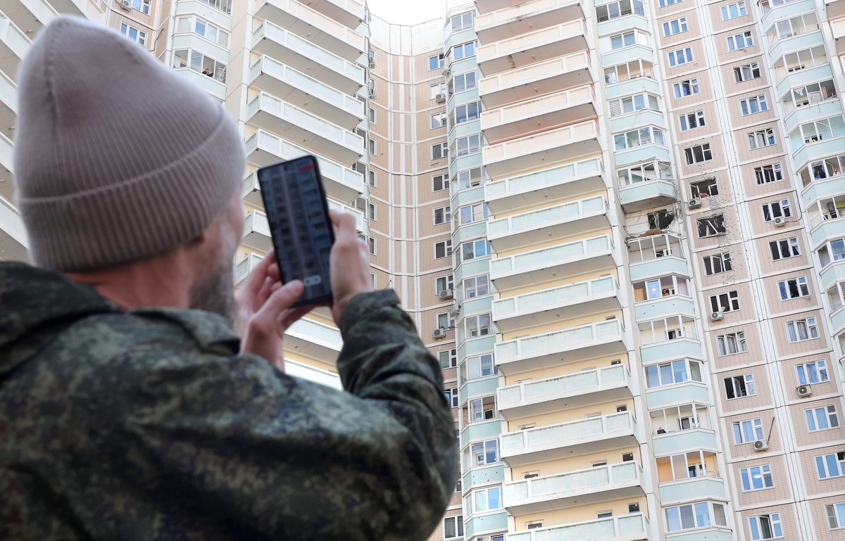 epa12966848 A person photographs a damaged apartment building following a drone attack outside Moscow, Russia, 17 May 2026. According to Russian authorities, at least three people were killed in overn ...