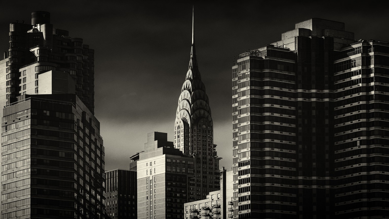 PIC BY ALEX TEUSCHER / CATERS NEWS - (PICTURED: The Chrysler building in New York) - A photographer has celebrated some of New Yorks most iconic landmarks in these moody portraits. The Empire State Bu ...