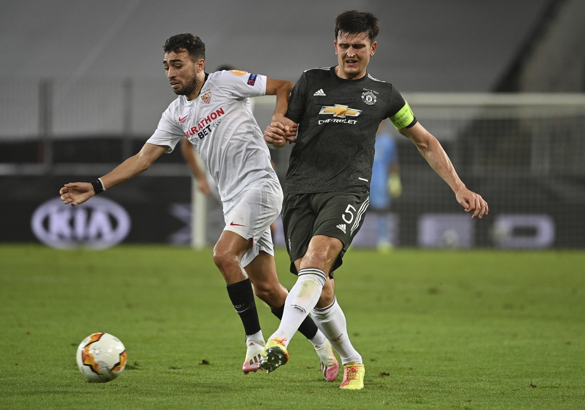 Sevilla's Munir El Haddadi, left and Manchester United's Harry Maguire vie for the ball during the Europa League semifinal soccer match between Sevilla and Manchester United in Cologne, Germ ...