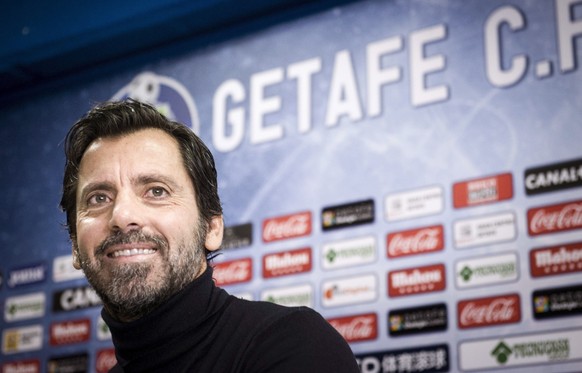 epa04547330 New head coach of Getafe, Spanish Quique Sanchez Flores, poses for photographers with a jersey featuring his name, during his official presentation in Madrid, Spain, 05 January 2015. Flore ...