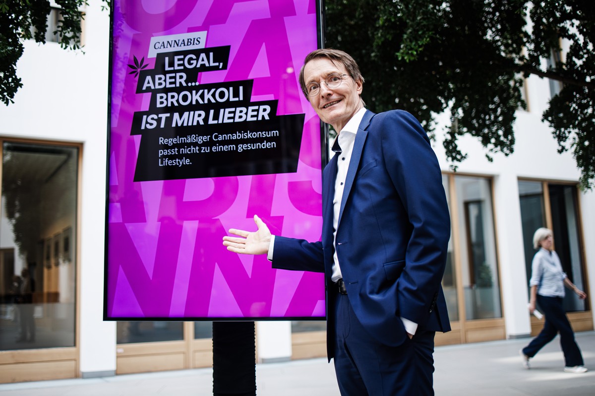 epa10802798 German Health Minister Karl Lauterbach poses in front of a display reading 'Cannabis. Legal, but... I prefer broccoli. Regular cannabis use does not fit into a healthy lifestyle.' ...