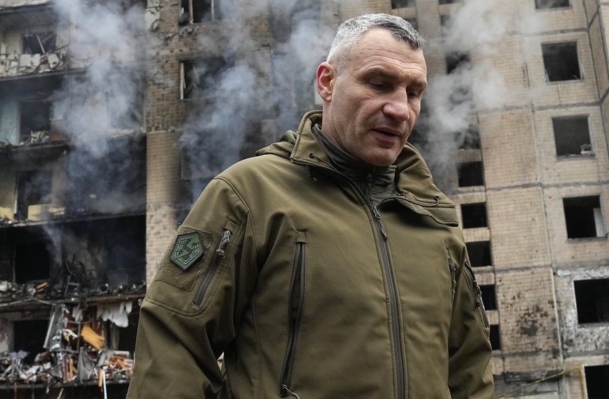 Mayor of Kyiv Vitali Klitschko inspects damages as smoke rises out from a destroyed apartment building after a Russian attack in Kyiv, Ukraine, Tuesday, Jan. 2, 2024. (AP Photo/Efrem Lukatsky)