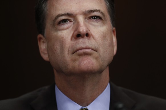 In this Wednesday, May 3, 2017, photo, then-FBI Director James Comey pauses as he testifies on Capitol Hill in Washington, before a Senate Judiciary Committee hearing. President Donald Trump abruptly  ...