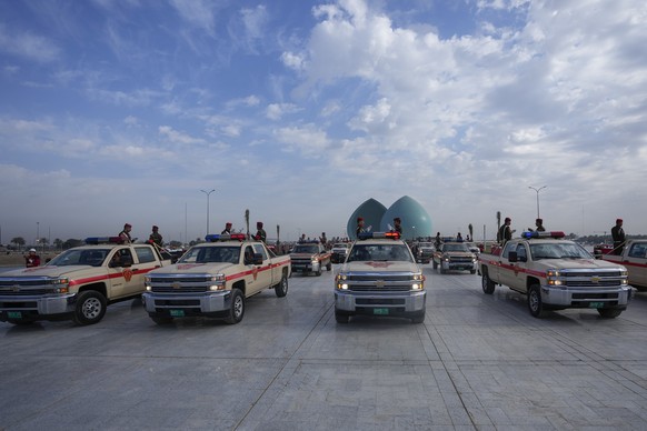 Military vehicles belonging to the Iraqi security forces carry body remains of people from the minority Yazidi, who were killed by Islamic State militants, after they were exhumed from a mass grave in ...