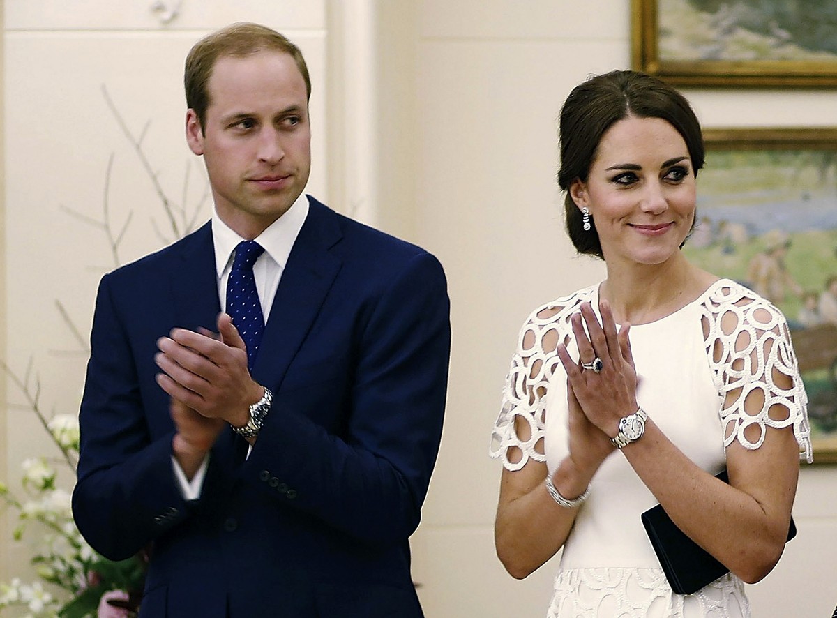 Britain's Prince William, left, and his wife Kate, the Duchess of Cambridge, listen to an address by the Australian Governor General Peter Cosgrove at a reception at Government House in Canberra, ...