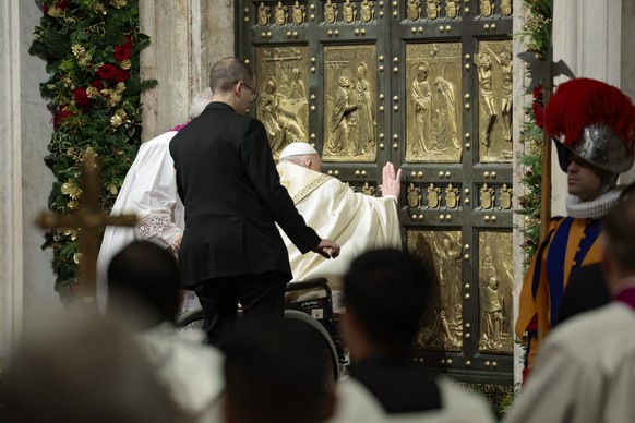 Pope Francis opens the Holy Door to mark the opening of the 2025 Catholic Holy Year, or Jubilee, in St. Peter&#039;s Basilica, at the Vatican, Dec. 24, 2024. (Remo Casilli/Pool Photo via AP)