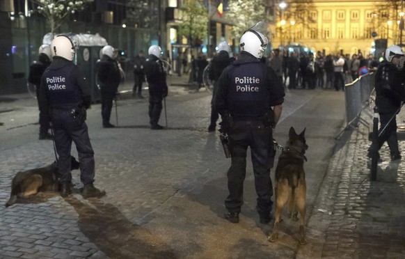 Police form a cordon during a conflict between supporters and opponents of Turkish President Recep Tayyip Erdogan near the Turkish embassy in Brussels on Thursday, March 30, 2017. (AP Photo/Olivier Ma ...