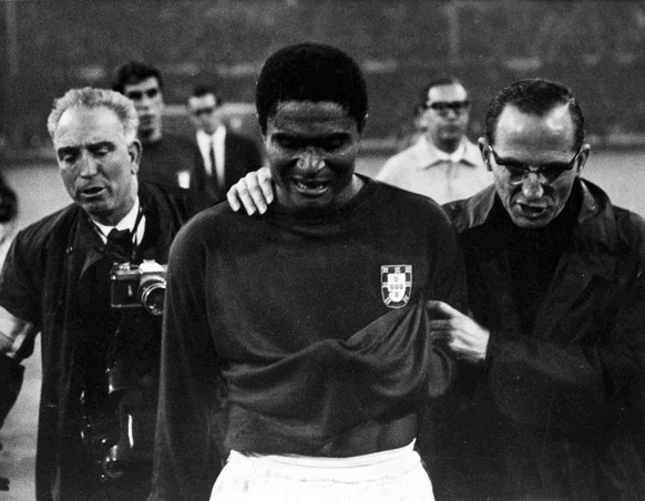 FILE - In this July 26, 1966 file photo, Portugal's star player Eusebio is led from the pitch in tears after England defeated Portugal 2-1 in the semifinal of the World Cup at Wembley, London. Wi ...