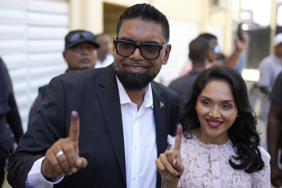 President Irfaan Ali, seeking another term, and his wife Arya Ali show their inked fingers after voting during general elections in Leonora, Guyana, Monday, Sept. 1, 2025. (AP Photo/Matias Delacroix)
 ...