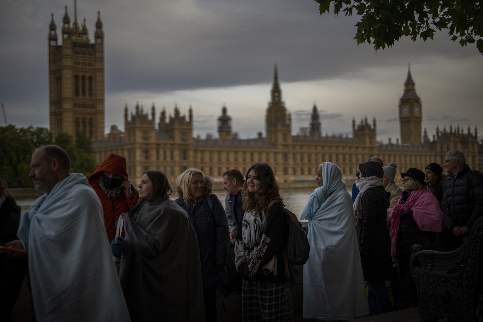 People queue to pay their respects to the late Queen Elizabeth II during the Lying-in State, outside Westminster Hall in London, Sunday, Sept. 18, 2022. Queen Elizabeth II, Britain's longest-reigning  ...