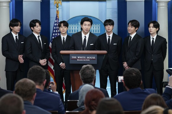 RM, center, accompanied by other K-pop supergroup BTS members from left, V, Jungkook, Jimin, Jin, J-Hope, and Suga speaks during the daily briefing at the White House in Washington, Tuesday, May 31, 2 ...