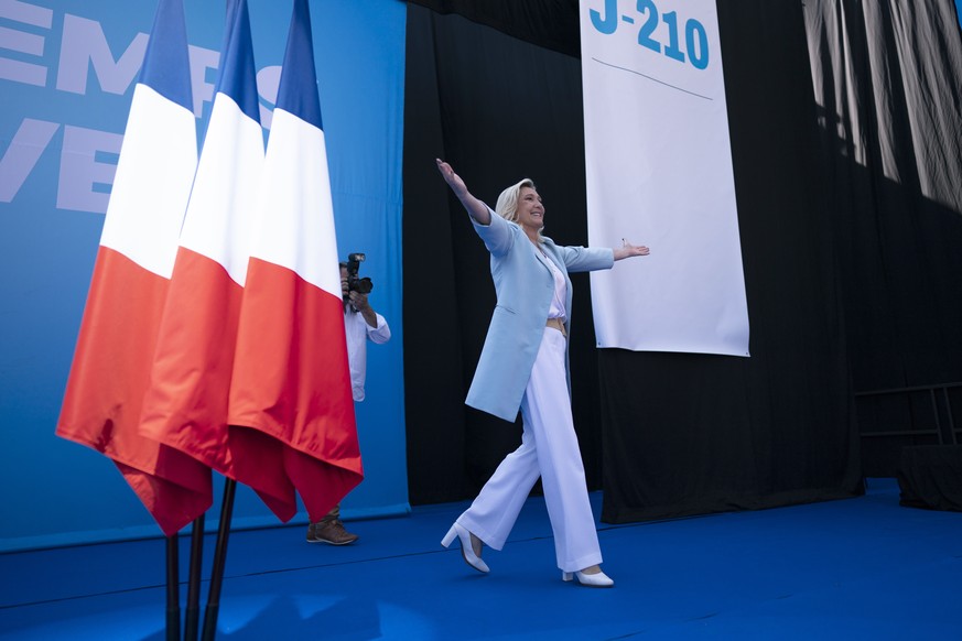 Marine Le Pen walks on stage, at a National Rally event in Frejus, Sunday, Sept. 12, 2021. Two politicians have formally declared their intentions to seek to become France