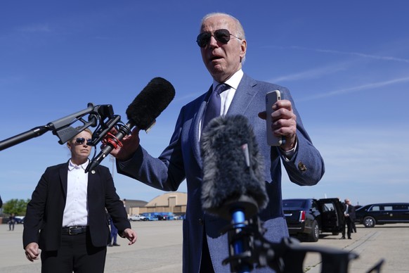 President Joe Biden talks with reporters before boarding Air Force One, Tuesday, April 11, 2023, at Andrews Air Force Base, Md. Biden is traveling the United Kingdom and Ireland in part to help celebr ...